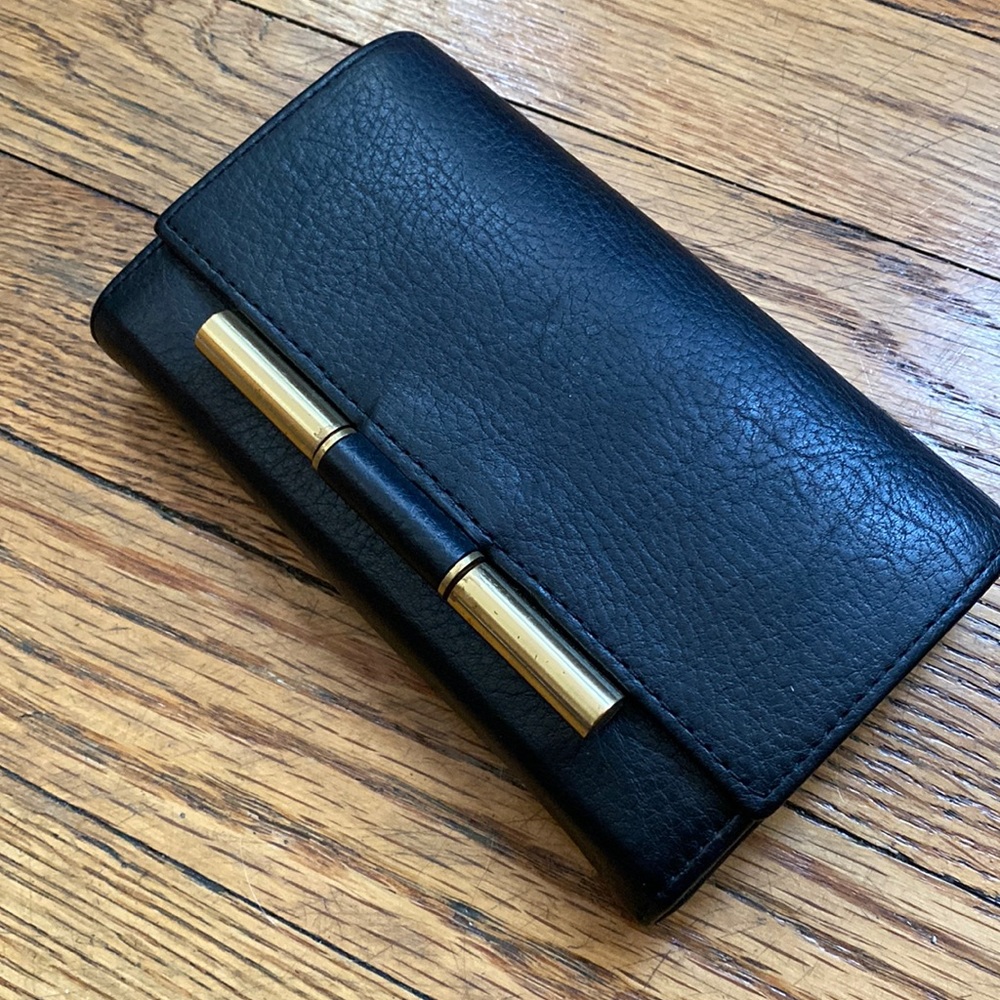 Hare + Hart black wallet with magnetic closure and gold hardware
